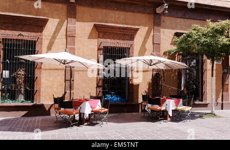 Symmetrical two outdoor dining tables at a restaurant in San Pedro Tlaquepaque, Jalisco, Mexico Stock Photo