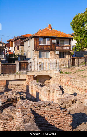 Street view of Nesebar, Bulgaria. Typical revival houses and ancient ruins in the old town. Vertical photo Stock Photo