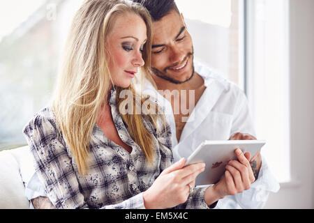 Couple looking at an iPad together Stock Photo