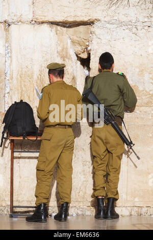 Israel, Rear view of soldiers praying at Wailing wall; Jerusalem Stock Photo
