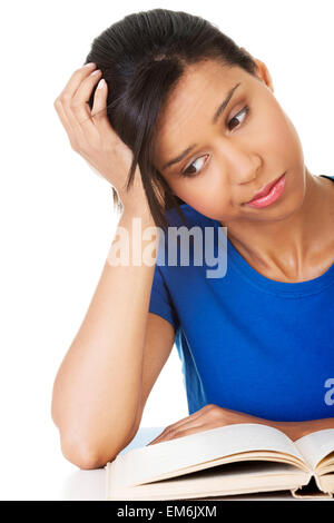 Woman studying at the desk being tired Stock Photo