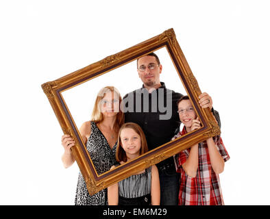 A young lovely family standing for white background and holding a picture frame in front of them. Stock Photo