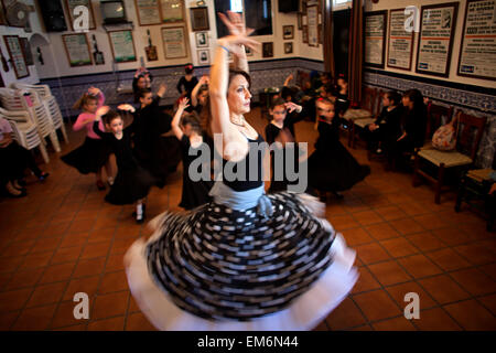 Olga Nuria, director of the Flamenco Dance group Savia Nueva teaches girls in the Pena Cultural Flamenca La Petenera in Paterna de Rivera, Cadiz province, Andalusia, Spain Stock Photo