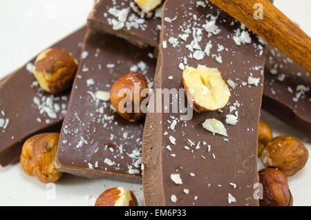 Dark chocolate hazelnuts and cinnamon on white Stock Photo