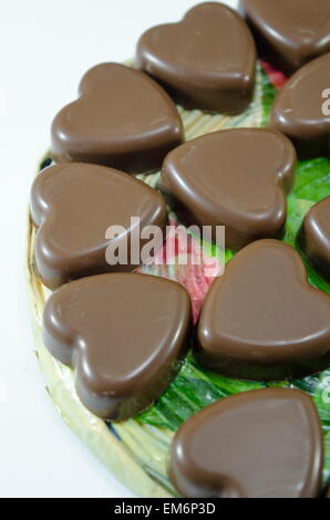 Deliciously looking heart shaped chocolate on white background Stock Photo