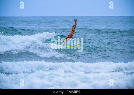 Surf in a carnival costumes, Bali, Indonesia.  Just take a fun and play with a friends. Stock Photo