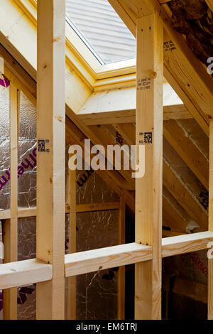 Interior of new building under construction showing timber roof joists and wood used in an attic space Stock Photo