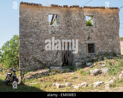 Houses ruins in the green landscape of Old Perithia Stock Photo