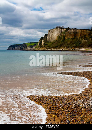 Waves breaking on to the shingle beach at Seaton looking west toward Beer cove in Devon England UK Stock Photo
