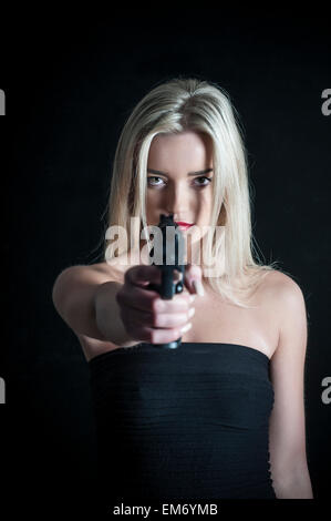 Woman holding a gun Stock Photo