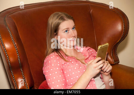 Teenage girl using iPhone mobile phone device indoors  MR  © Myrleen Pearson Stock Photo