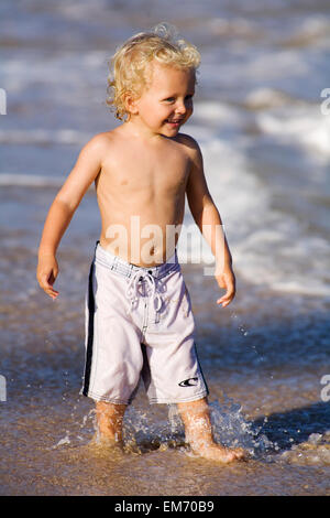 little blond boy shirtless playing in the garden Stock Photo, Royalty ...