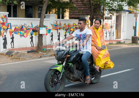 A man and woman on a motorbike in Fort Kochi, Kerala India Stock Photo