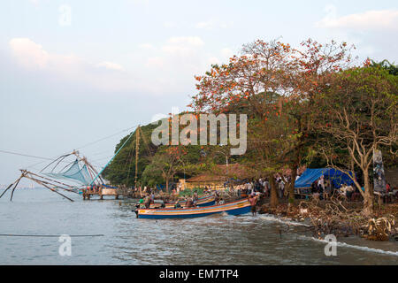 Chinese Fishing nets and fishing boats on the beach at Fort Kochi, Kerala India Stock Photo