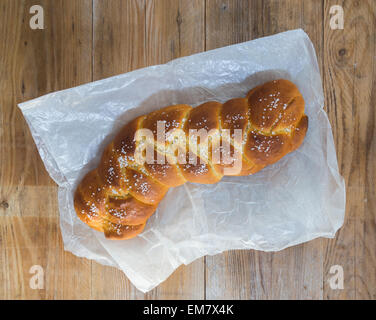 Braided Bread on rustic wood and parchment paper. Stock Photo