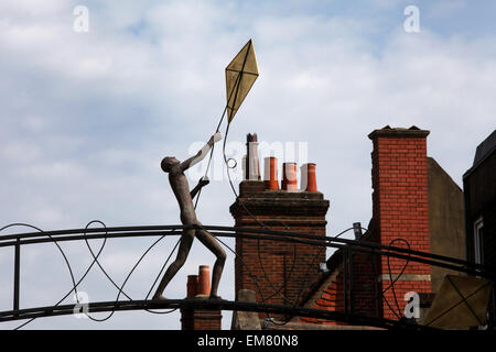 The Kite Flyer sculpture above Parchment Street in Winchester. A bronze figure of a man flying a kite Stock Photo