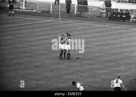 1966 World Cup Final at Wembley Stadium. England 4 v West Germany 2, after extra time. England's Martin Peters is congratulated by teammates Geoff Hurst and Roger Hunt (10) after his goal put England 2-1 ahead. 30th July 1966. Stock Photo