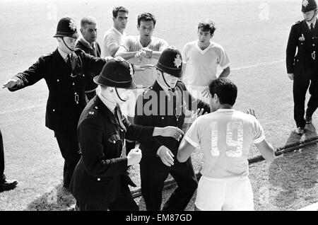 World Cup Quarter Final match at Hillsborough, Sheffield. West Germany 4 v Uruguay 0. Referee Jim Finney calls for police assistance after Hector Silva refuses to leave the pitch after being ordered off for a foul on Germany's Helmut Haller. 23rd July 1966. Stock Photo