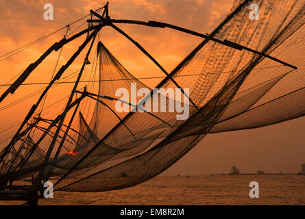 Sunset by the Chinese Fishing nets in Fort Kochi, Kerala India Stock Photo