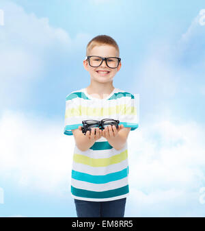 smiling boy in eyeglasses holding spectacles Stock Photo