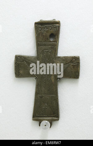 Great Moravian bronze cross from Velka Maca decorated with engraved figures displayed at the exhibition 'Great Moravia and the Beginnings of Christianity' in Prague, Czech Republic. The Encolpion cross from the 10th century was discovered in the village of Velka Maca near Nitra, Slovakia. The cross used to be depicted on the 10 Slovak koruna coin. The exhibition presenting medieval treasures and original artefacts of the first Slavic state runs in Prague Castle till June 28, 2015. Stock Photo