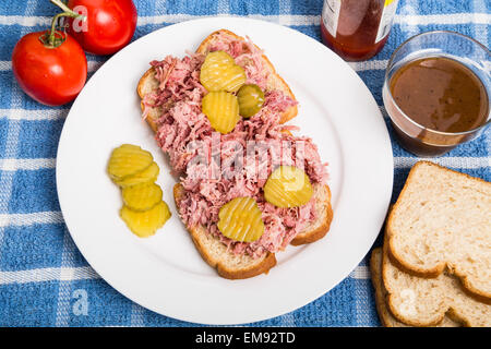 Pulled Pork Sandwich on White Plate with Sliced Pickles Stock Photo