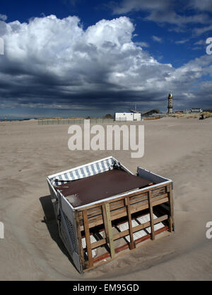 A beach chair was blown over by the wind at the beach of the seaside resort Rostock-Warnemuende, Germany, 17 April 2015. The weather at the Baltic sea is sunny but windy. Photo: BERND WUESTNECK/dpa Stock Photo