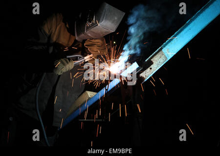 Welding operator welds metal constructions in Kiev, Ukraine. Stock Photo