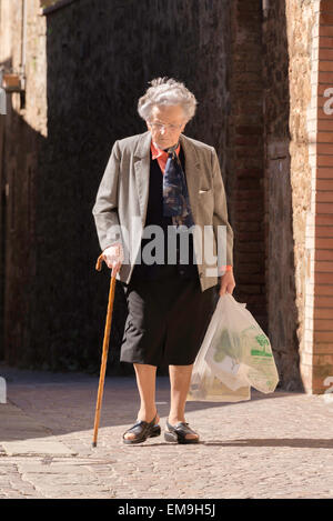 Old lady going home from shopping in Montalcino, Tuscany, Italy Stock Photo