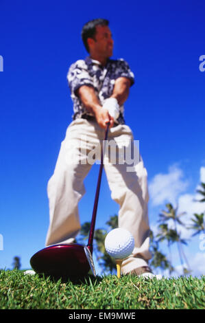 Hawaii, Golfer Sets Up His Shot, View From Below. Stock Photo