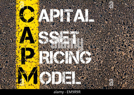 Business Acronym CAPM – Capital asset pricing model. Yellow paint line on the road against asphalt background. Conceptual image Stock Photo