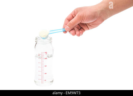 putting powdered milk into a baby bottle with clipping path Stock Photo