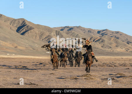Five Kazakh eagle hunters on the steppes, Western Mongolia Stock Photo