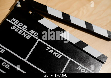 Color picture of a cinema clap on a wooden table. Stock Photo