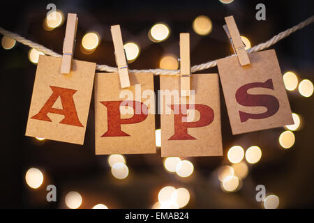 The word APPS spelled out on clothespin clipped cards in front of glowing lights. Stock Photo