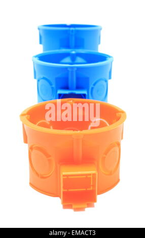 Orange and blue plastic electrical boxes on white background, junction boxes, accessories for engineering jobs Stock Photo