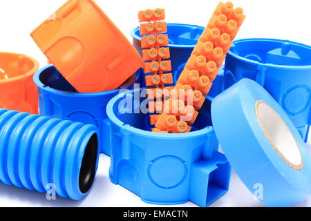 Orange and blue electrical boxes with components for use in electrical installations, accessories for engineering jobs Stock Photo