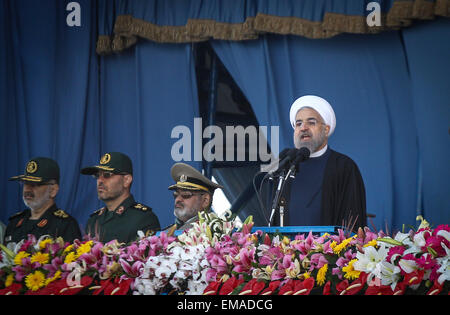 Tehran, Iran. 18th Apr, 2015. Iranian President Hassan Rouhani (R) delivers a speech during the Army Day parade in Tehran, Iran, on April 18, 2015. Different units of Iranian army staged parades in a ceremony to show the latest Iranian military achievements. © Ahmad Halabisaz/Xinhua/Alamy Live News Stock Photo