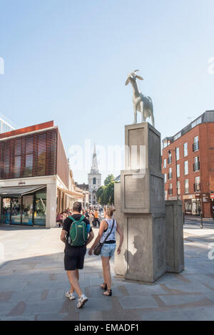 London tourists walk past 'I Goat' by Kenny Hunter, the winning design of the Spitalfields Sculpture Prize 2010. Stock Photo
