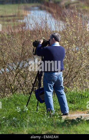 Birdwatching, or birding, birders, wildlife observation binoculars, scopes, optics, tripods at Southport, Merseyside, UK 18th April, 2015. UK Weather: Birdwatching in RSPB Marshside Reserve. Part of the internationally important Ribble Estuary, which has some of the best lowland wet grassland in the north-west of England. It is an important refuge in winter for pink-footed geese, wigeons, black-tailed godwits and golden plovers and in spring provides nesting places for lapwings and redshanks, which are declining elsewhere. Stock Photo
