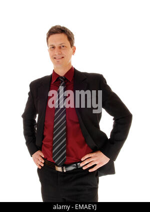 An business man in a suit standing isolated for white background with his hands on his hips and smiling. Stock Photo
