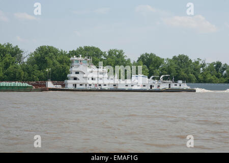 A pusher tug on the Ohio River moving a barge upstream Stock Photo