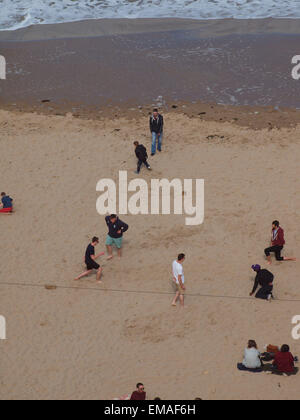Newcastle Upon Tyne, UK, 18th April, 2015. UK Weather: Beach scene on a cloudy sunny afternoon at '' King Edwards Bay '', Tynemouth as people relax in the mild tempertures. Credit:  james walsh/Alamy Live News Stock Photo