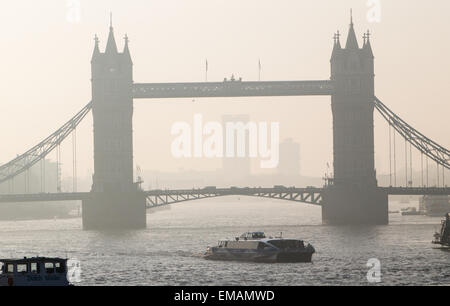 Heavy smog lies in the morning air with an easterly view of Tower Bridge in London showing pollution from carbon emissions