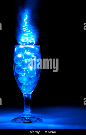 Clear Marbles in a Wine glass with blue light painting Stock Photo