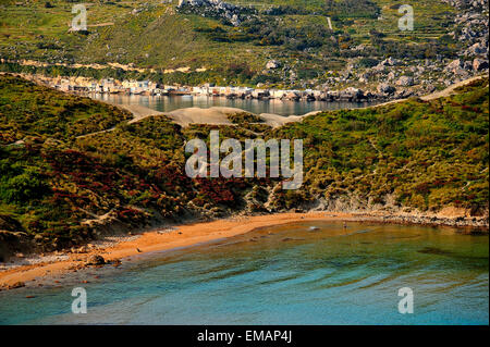 The 'golden sandy' beach of 'Ghajn Tuffieha Bay' in northwest Malta. In the background visible Gnejna Bay. Stock Photo