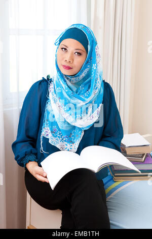 Modern muslim woman reading a book Stock Photo