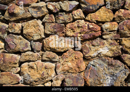 Old stone wall constructed from old copper mine stone Stock Photo