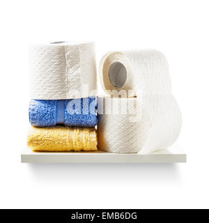 Shelf with toilet paper rolls and towels isolated on white background. Bathroom cabinet. Object with clipping path Stock Photo