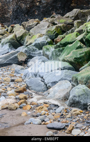 Layers of different size and coloured rocks on the beach, in Whitby, North Yorkshire, England. On 18th April 2015. Stock Photo
